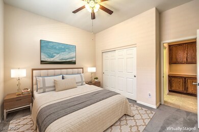 Carpeted bedroom featuring baseboards, ceiling fan