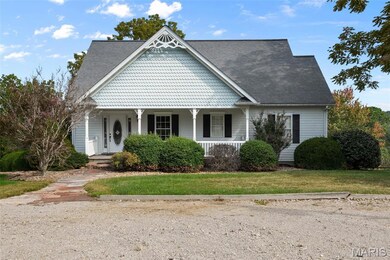 Victorian home featuring covered porch and a front lawn
