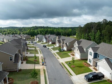 Drone / aerial view featuring a residential view and a view of trees