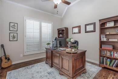 A dedicated study with gorgeous wood floors, crown