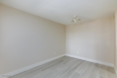 Unfurnished room with a chandelier, light wood-sty