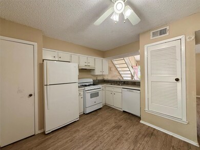 Kitchen featuring white appliances, a sink, a tex