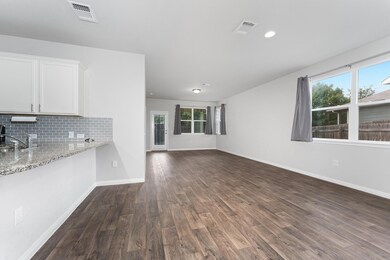 Unfurnished living room featuring dark wood-style