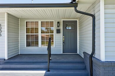 Entrance to property featuring covered porch
