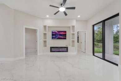 Unfurnished living room featuring marble tiled flo