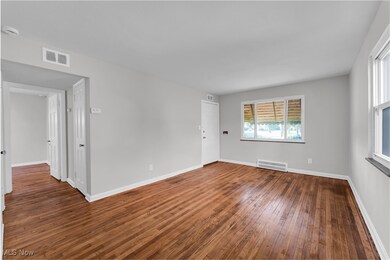 Spare room featuring wood-type flooring and a smoke detector