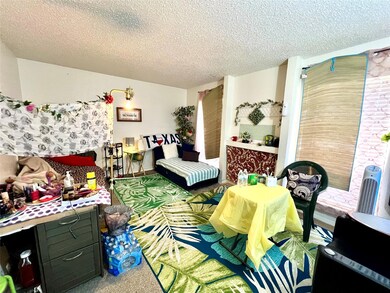 Bedroom with carpet floors and a textured ceiling