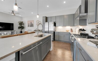 Kitchen featuring wall chimney range hood, tastef