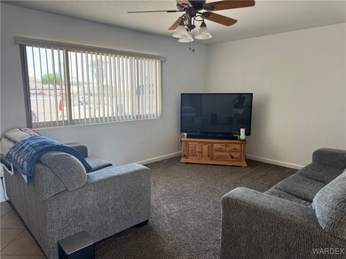 Living room with ceiling fan and carpet