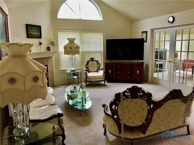Living room featuring fireplace, french doors into