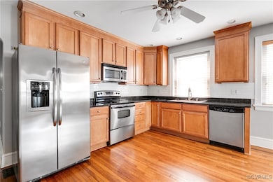 Kitchen featuring stainless steel appliances, dark