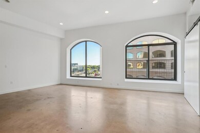 Empty room with finished concrete flooring, reces