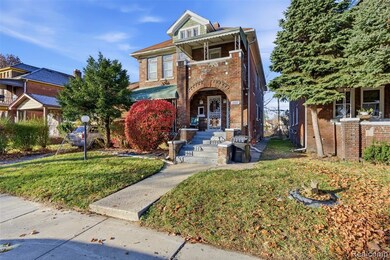 View of front facade featuring a front yard and brick siding