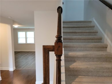 Stairway with baseboards and wood finished floors