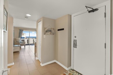 Corridor featuring light tile patterned flooring
