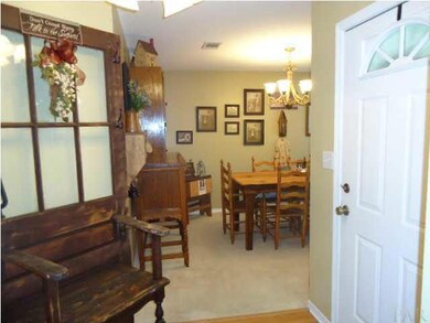 View from kitchen through foyer into formal dining room.