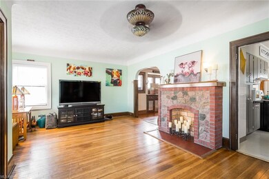 Original wood floors, stone fireplace, and tons of light in the formal living room.
