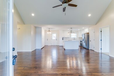 Walk through the front door and enjoy the open floor plan with high ceilings and gleaming hardwood floors.