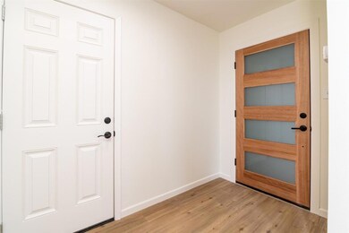 Doorway to outside featuring light wood-style flo