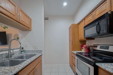 Kitchen includes double-sink, electric range, buil