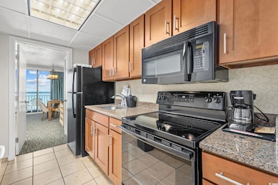 Kitchen with decorative backsplash, light stone co