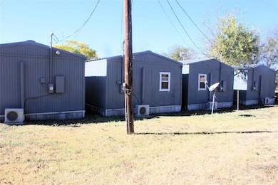 View of home's exterior featuring ac unit, a yard,