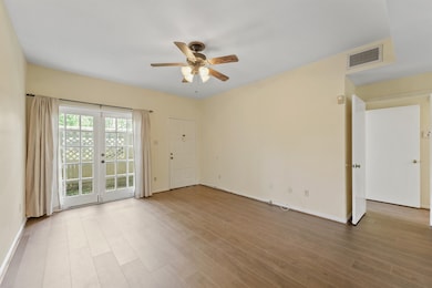 Light-filled living room with French doors opening