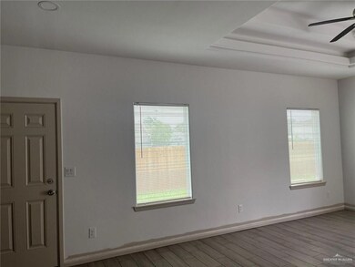Unfurnished room featuring ceiling fan and light wood-style floors