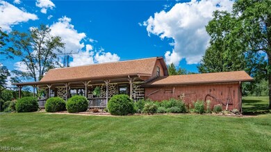 Rear view of property with a lawn