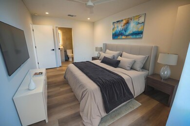 Bedroom featuring light wood-type flooring, reces
