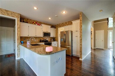 FRESHLY PAINTED KITCHEN CABINETS WITH GRANITE COUN