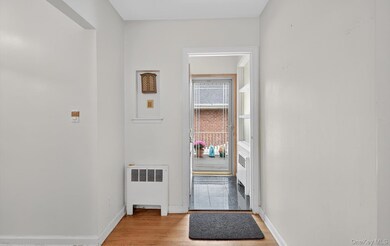 Entryway with radiator heating unit and wood finished floors