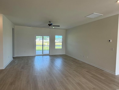 Unfurnished room with ceiling fan and wood finished floors
