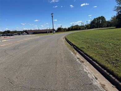 View of asphalt road with curbs