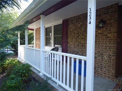 Classic sitting porch is a great shady place to en
