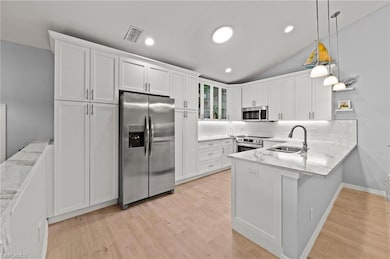 Kitchen with stainless steel appliances, hanging l