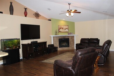 Featuring vaulted ceilings, fireplace, wood floor