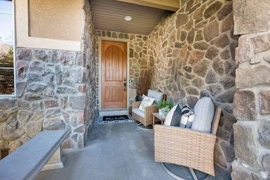 Doorway to property with stone siding