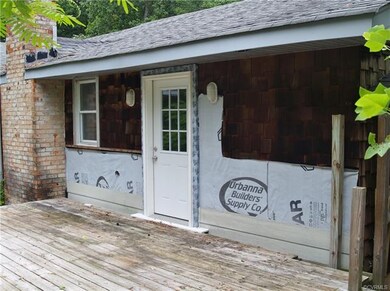 Rear of dwelling, lacks siding.