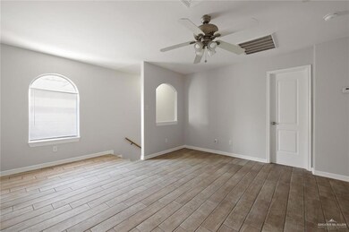 Empty room with ceiling fan and wood finished floors