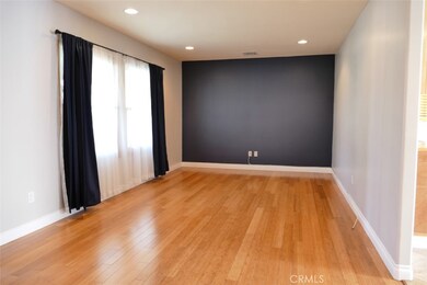Spacious light & open living room with lovely hardwood flooring.