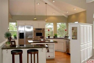 This kitchen is timeless has hardwood floors, gran