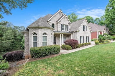 View of front of house featuring brick siding, a front yard, and a shingled roof