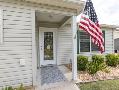 Front entry with brick-style curbing and easy main