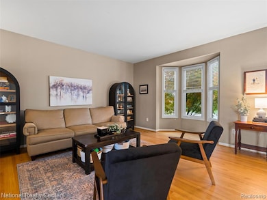 Living room featuring light wood-style flooring and arched walkways