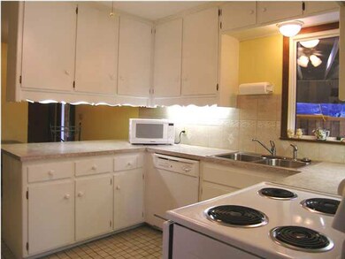 A VIEW OF THE KITCHEN WITH NEWER COUNTERS AND TILE