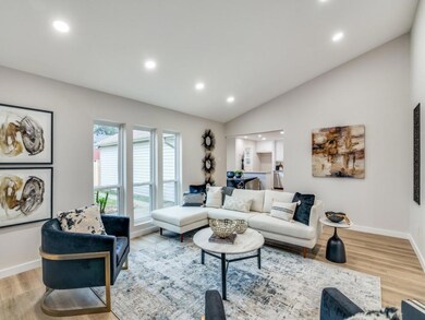 Living room featuring vaulted ceiling and light wo