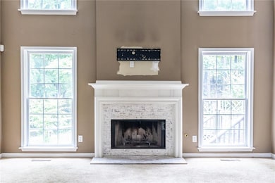 Enjoy the brick fireplace with views to the wooded