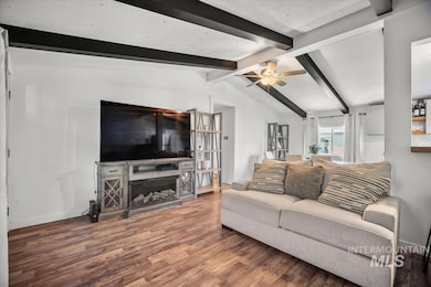 Living area featuring wood finished floors, a fireplace, and a ceiling fan