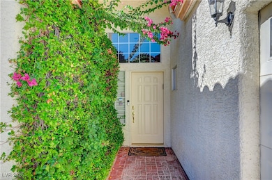 Doorway to property featuring stucco siding